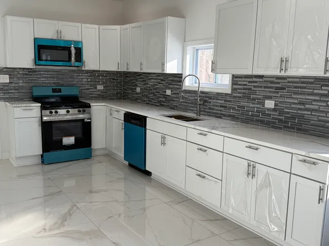 a kitchen with stainless steel appliances granite countertop a sink stove and cabinets