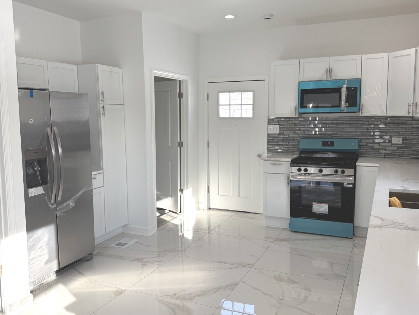 15351 3rd Avenue Phoenix, IL 60426 - Photo 3 of 12 a kitchen with stainless steel appliances granite countertop a refrigerator and a stove top oven