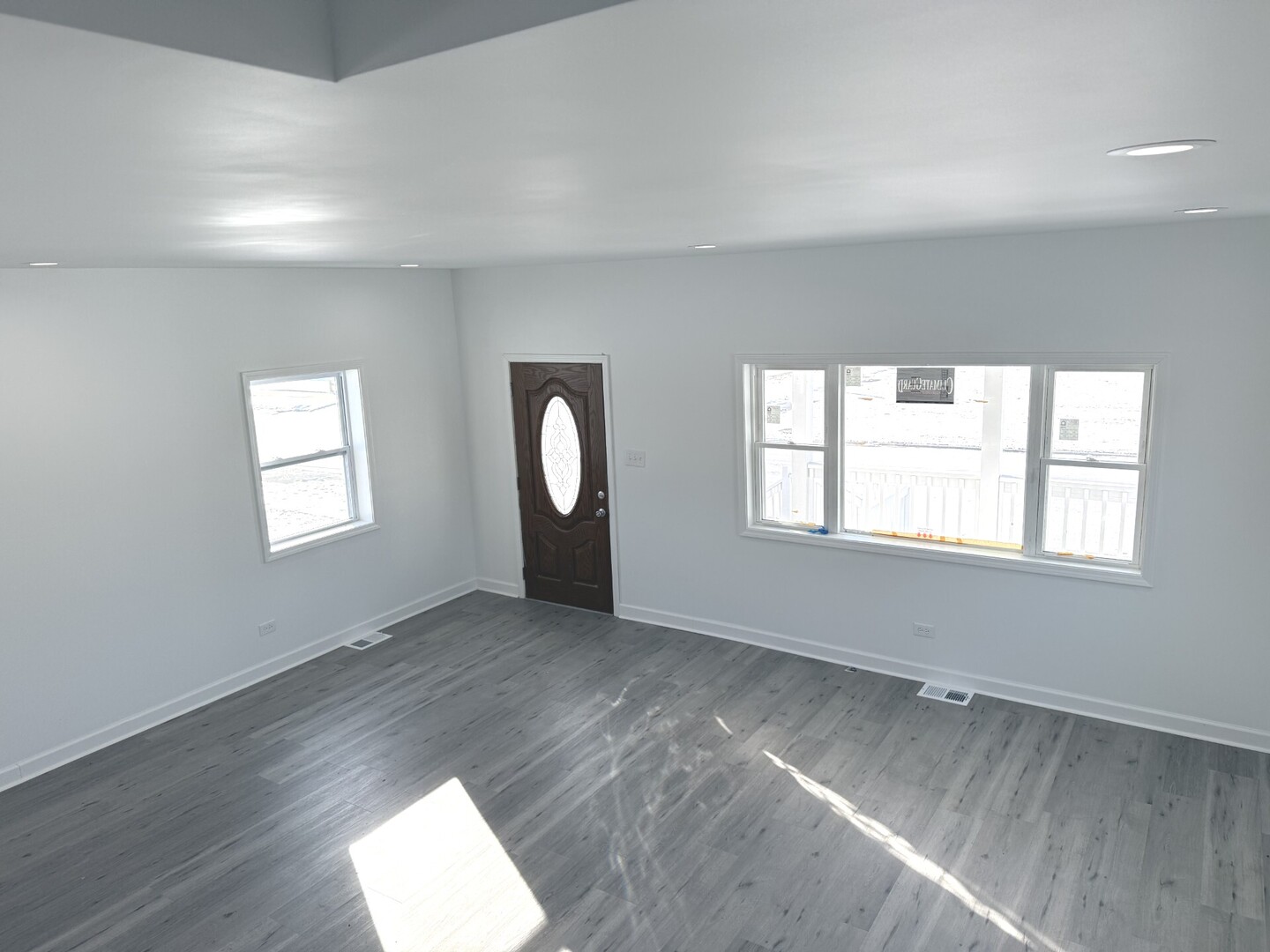15351 3rd Avenue Phoenix, IL 60426 - Photo 5 of 12 an empty room with wooden floor and windows