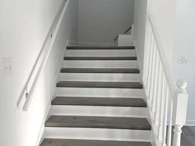 a view of staircase with white walls