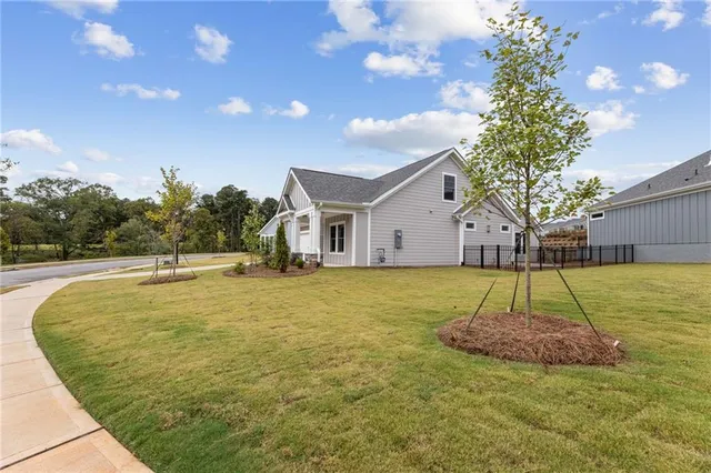 a view of a house with a tub and wooden fence