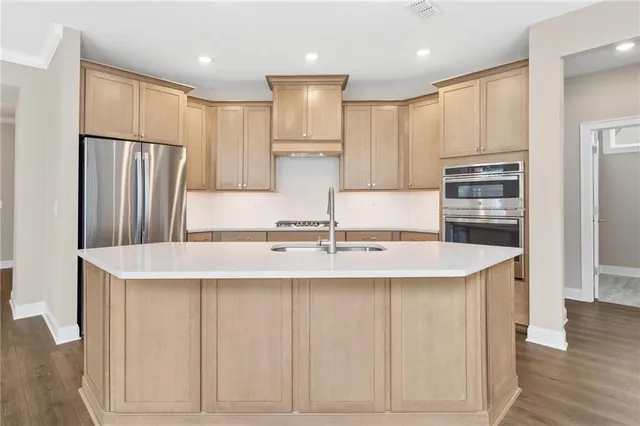 a kitchen with granite countertop a refrigerator stove and sink