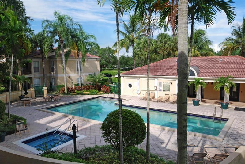 949 Riverside Drive, Unit 435 Coral Springs, FL 33071 - Photo 12 of 14 front view of house with a yard and potted plants