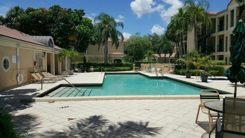 949 Riverside Drive, Unit 435 Coral Springs, FL 33071 - Photo 13 of 14 a view of a patio with chairs and plants