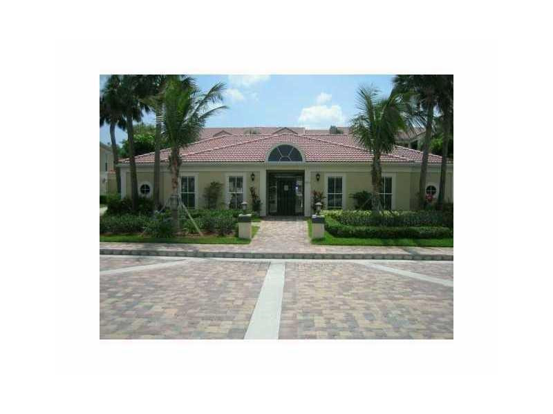 949 Riverside Drive, Unit 435 Coral Springs, FL 33071 - Photo 2 of 14 a view of a white house with a yard and potted plants