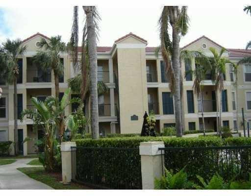 949 Riverside Drive, Unit 435 Coral Springs, FL 33071 - Photo 3 of 14 a front view of a residential apartment building with a yard