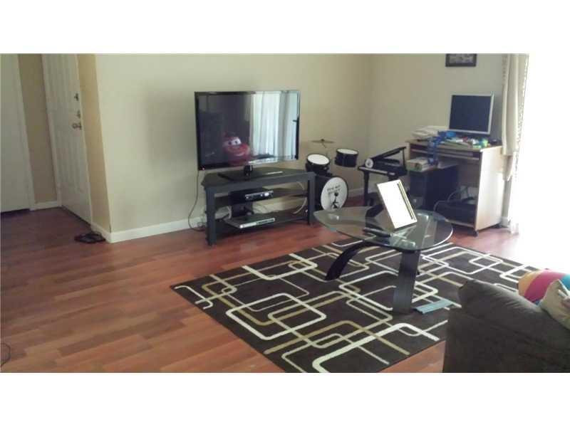 949 Riverside Drive, Unit 435 Coral Springs, FL 33071 - Photo 6 of 14 a kitchen view of a stove and a wooden floor
