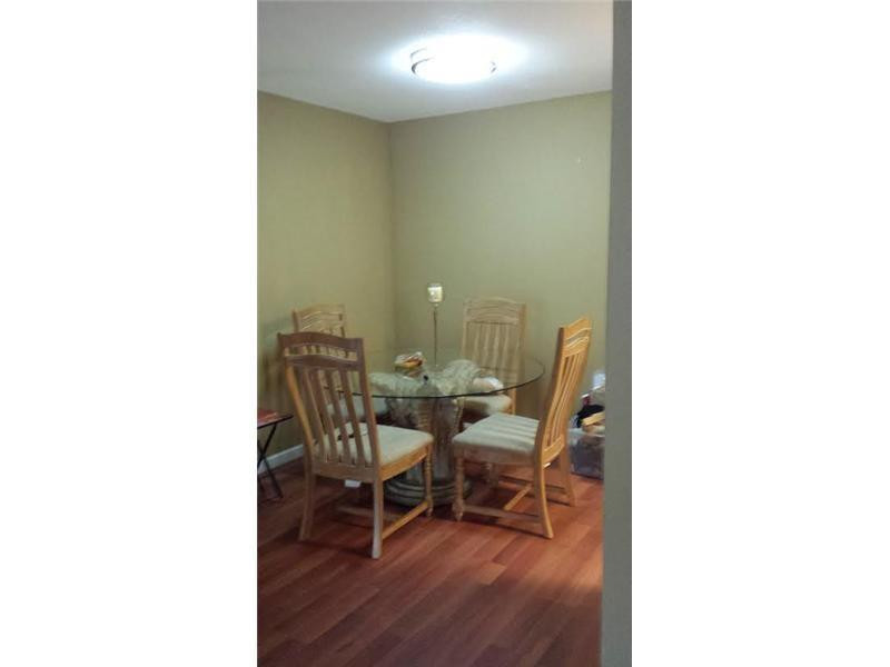 949 Riverside Drive, Unit 435 Coral Springs, FL 33071 - Photo 7 of 14 a living room with furniture and a dining table