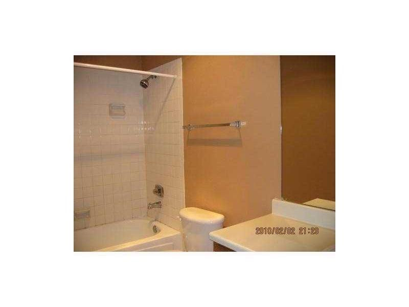 949 Riverside Drive, Unit 435 Coral Springs, FL 33071 - Photo 9 of 14 a bathroom with a shower and a toilet