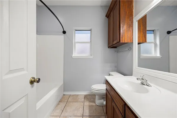 a bathroom with a sink toilet and mirror