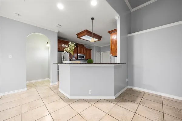 a view of a hallway with entryway cabinet and chandelier