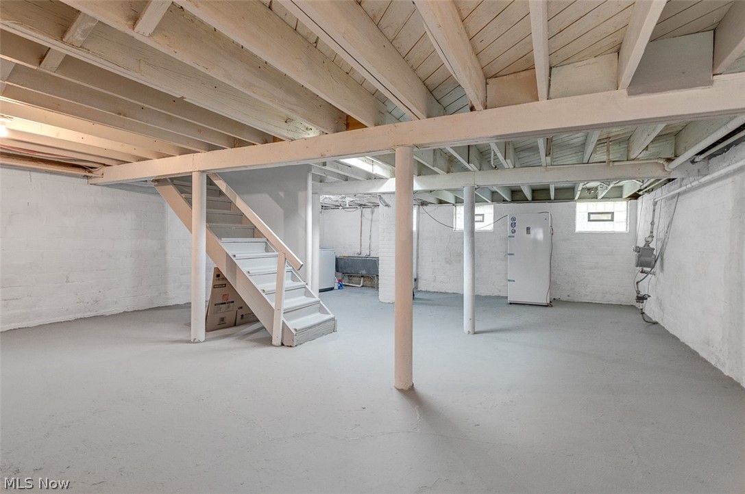 2972 Yorkshire Road Cleveland Heights, OH 44118 - Photo 34 of 44 Expansive unfinished basement featuring a painted concrete floor, exposed ceiling joists, and block wall construction