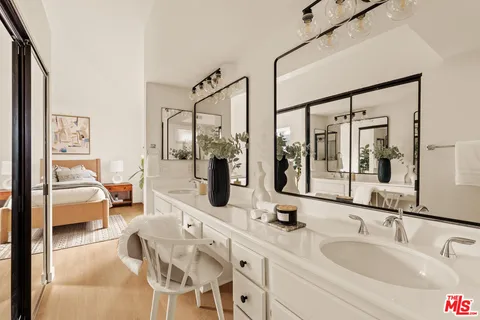 a bathroom with a double vanity sink and mirror