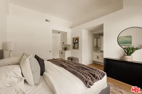 a bedroom with a bed and a dresser