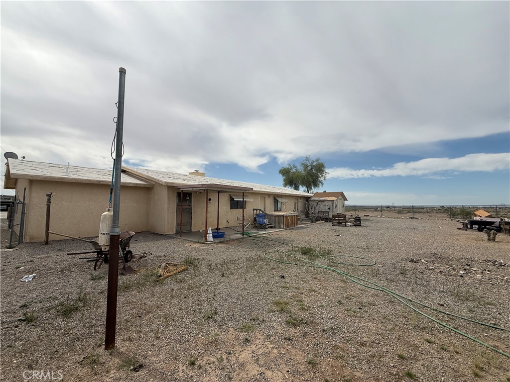151080 Deerpath Road Big River, CA 92242 - Photo 18 of 24 a view of a house with a backyard and a chair
