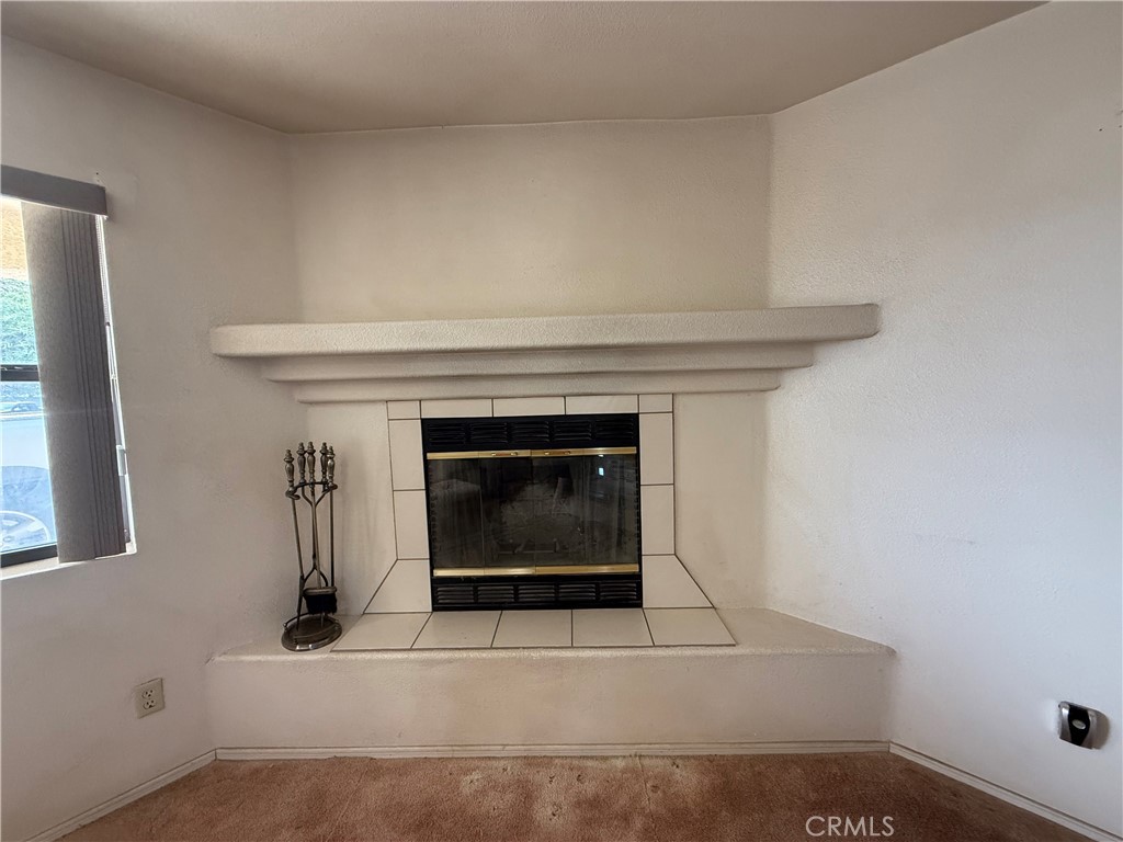 151080 Deerpath Road Big River, CA 92242 - Photo 4 of 24 a living room with a fireplace and a rug