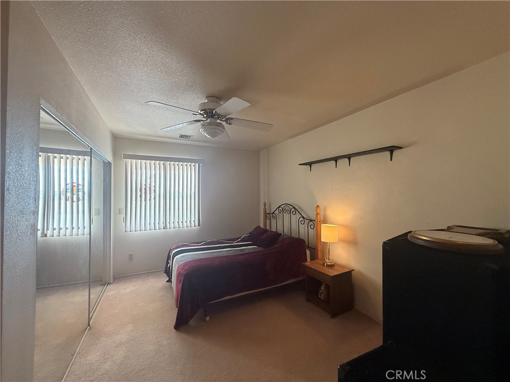 151080 Deerpath Road Big River, CA 92242 - Photo 9 of 24 a bedroom with a bed and a ceiling fan