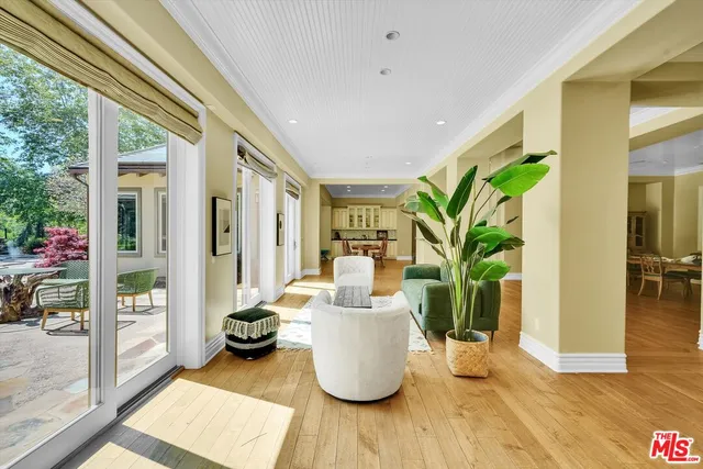 a living room with a large window and a bed