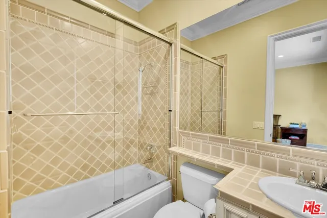 a view of a yard with plants and large trees