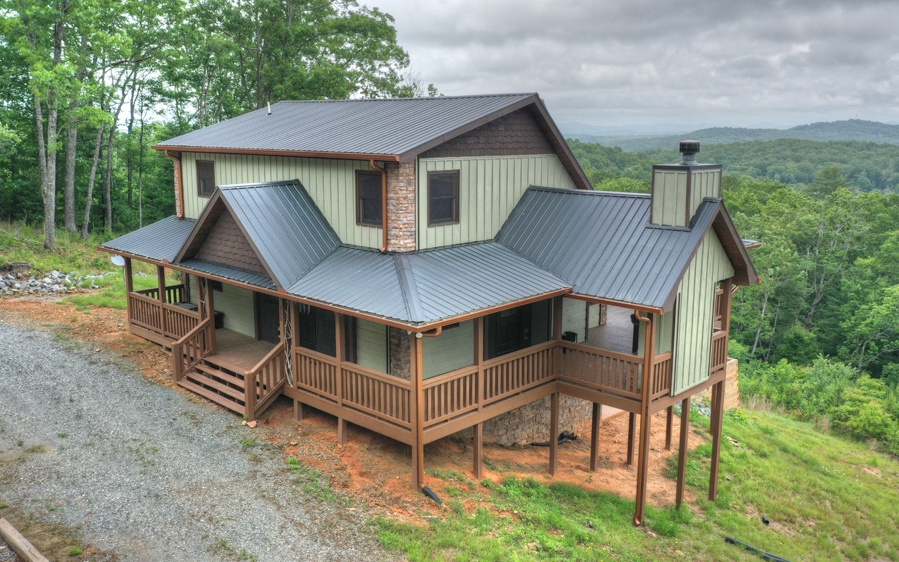 a view of a house with a yard and deck