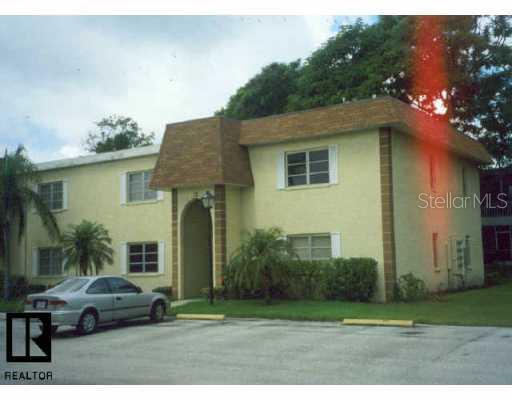 343 McMullen Booth Road, Unit 151 Clearwater, FL 33759 - Photo 1 of 1 a front view of a house with a garden