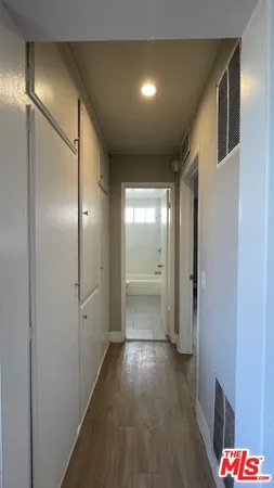 a view of hallway with wooden floor