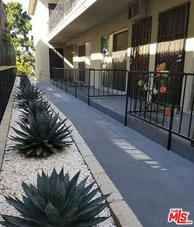 a view of a porch with a door and wooden floor