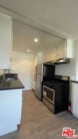 a kitchen with stainless steel appliances granite countertop a stove and a sink