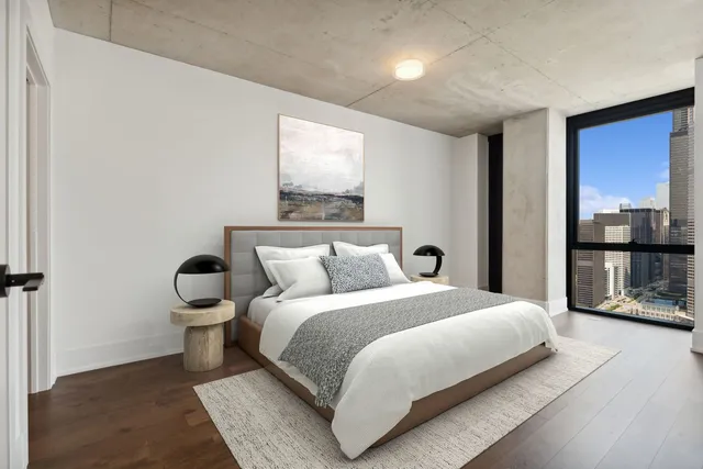 a bedroom with a bed and large mirror