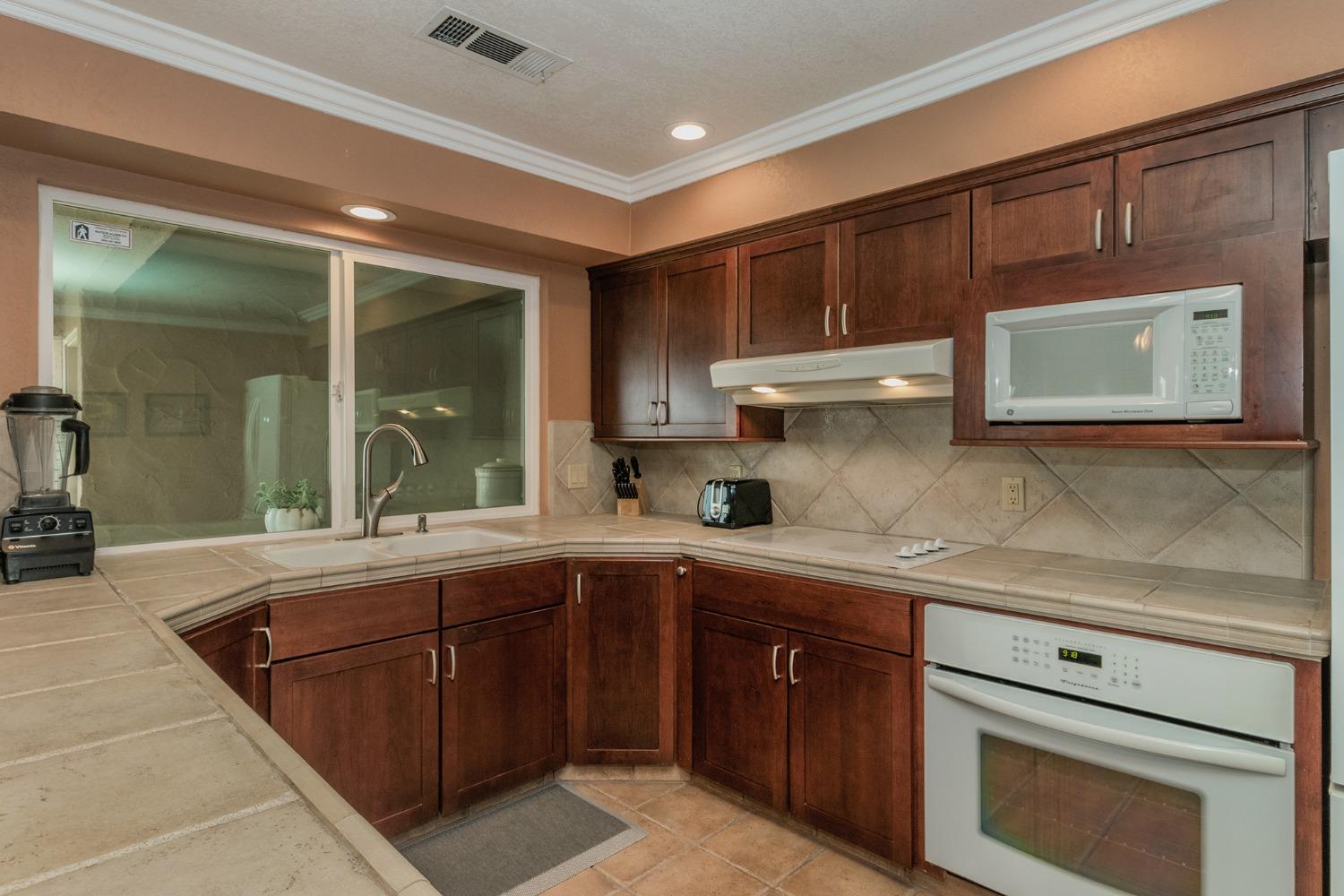 6233 South Armstrong Avenue Fowler, CA 93625 - Photo 12 of 30 a kitchen with a sink cabinets and window