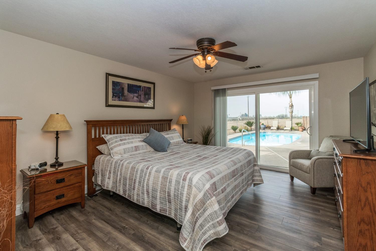 6233 South Armstrong Avenue Fowler, CA 93625 - Photo 14 of 30 a bedroom with a bed and a chandelier