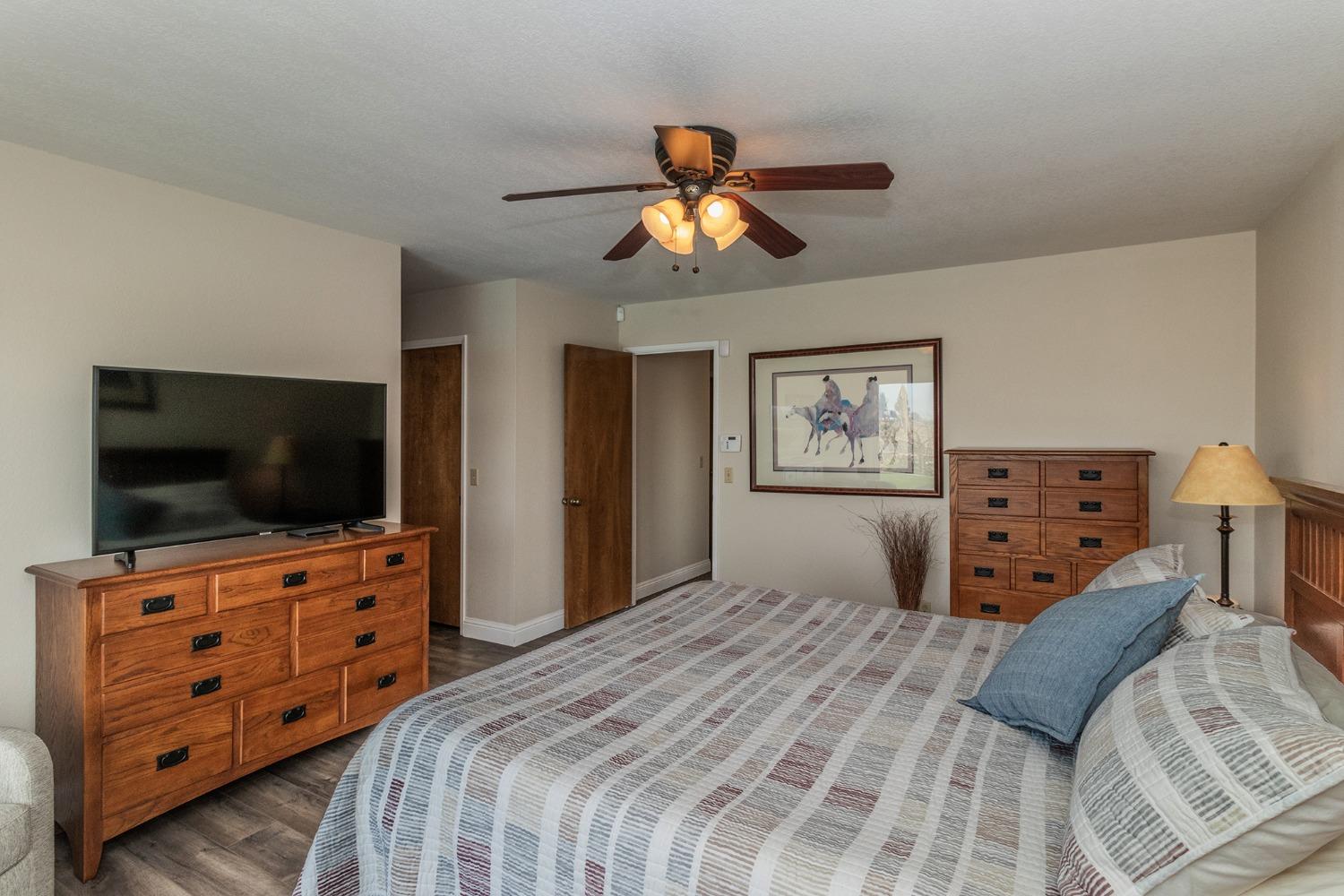 6233 South Armstrong Avenue Fowler, CA 93625 - Photo 15 of 30 a bedroom with a bed and a flat tv screen on dresser