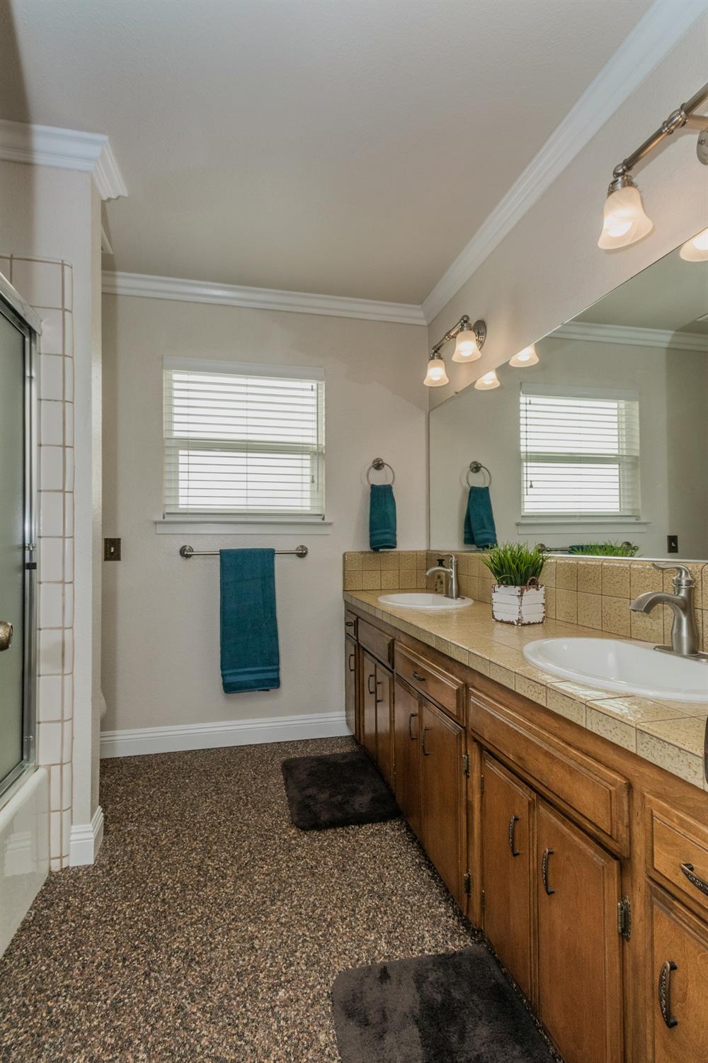 6233 South Armstrong Avenue Fowler, CA 93625 - Photo 18 of 30 a spacious bathroom with a granite countertop sink and a mirror