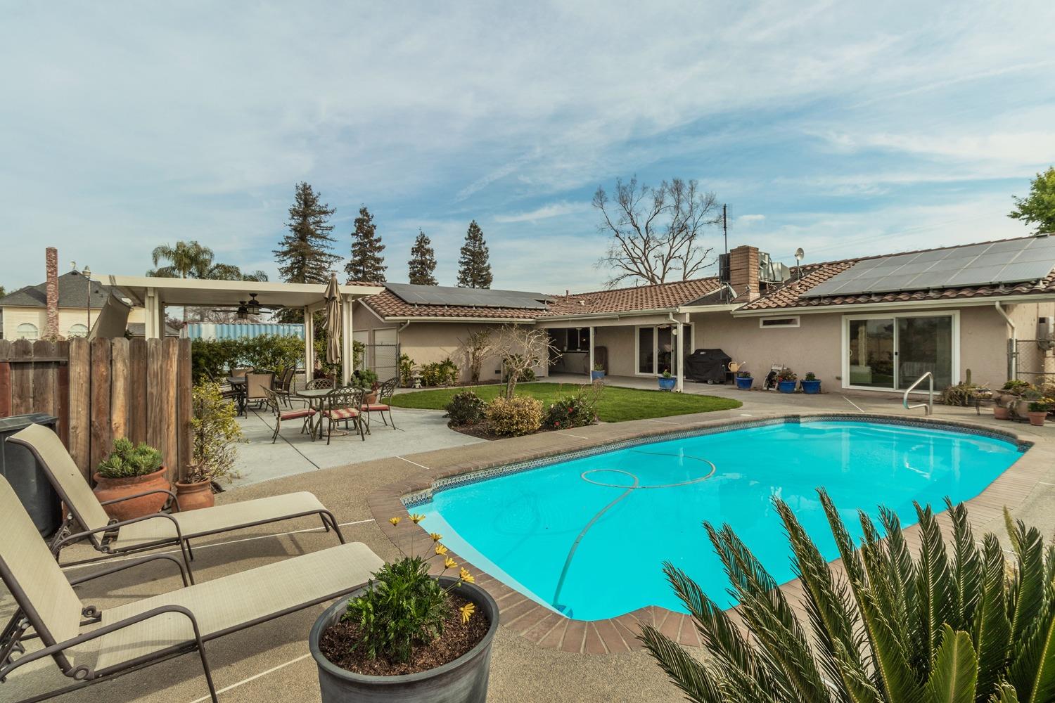6233 South Armstrong Avenue Fowler, CA 93625 - Photo 26 of 30 a view of a house with swimming pool and sitting area