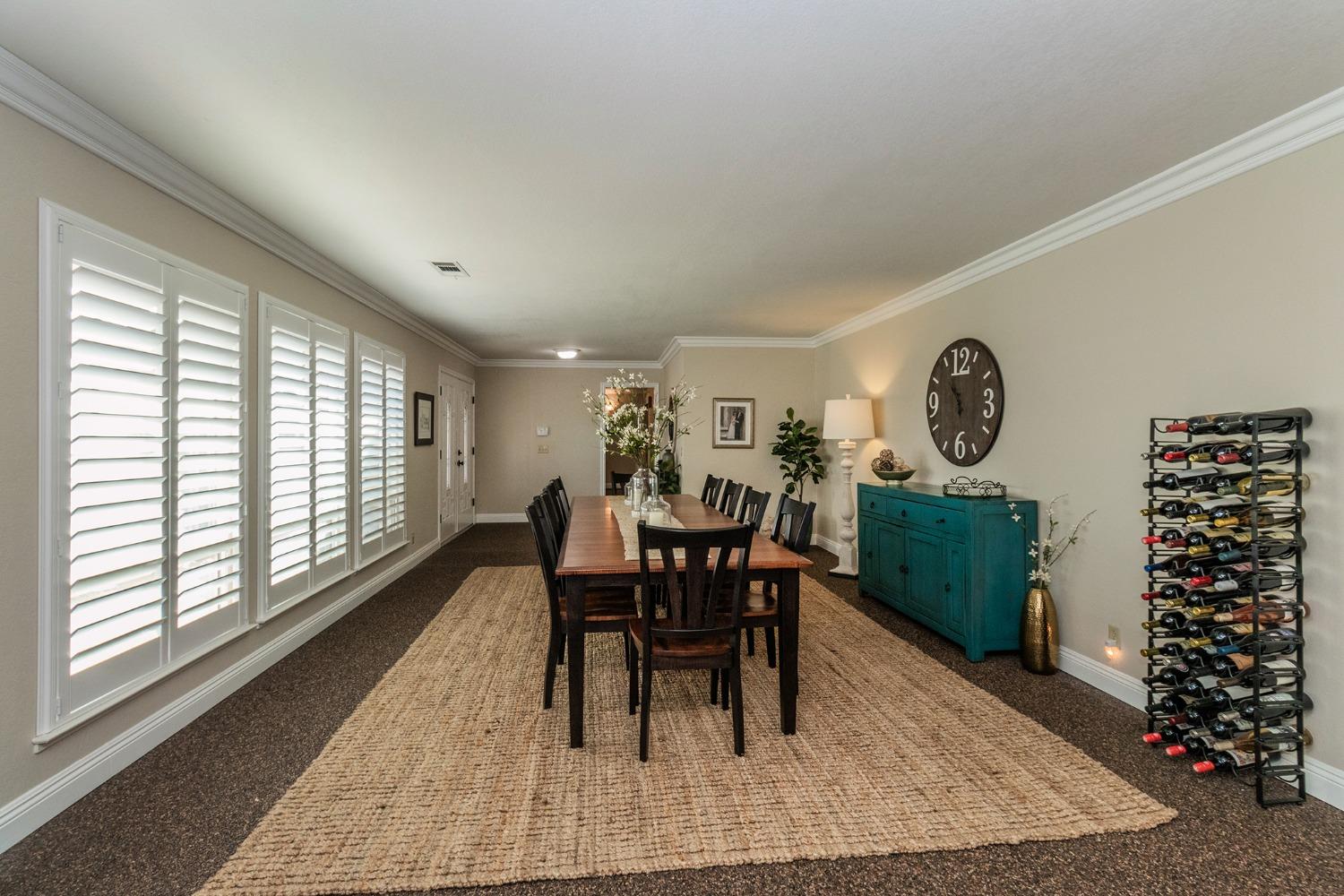6233 South Armstrong Avenue Fowler, CA 93625 - Photo 4 of 30 a dining room with furniture a rug and a large window