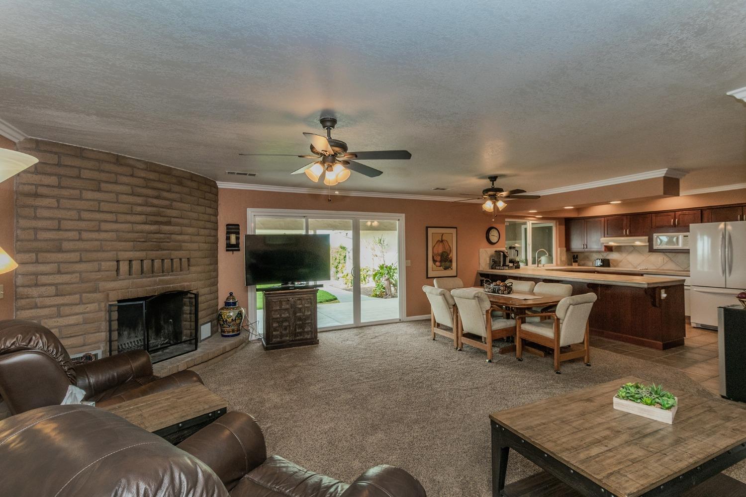 6233 South Armstrong Avenue Fowler, CA 93625 - Photo 7 of 30 a living room with furniture and a fireplace