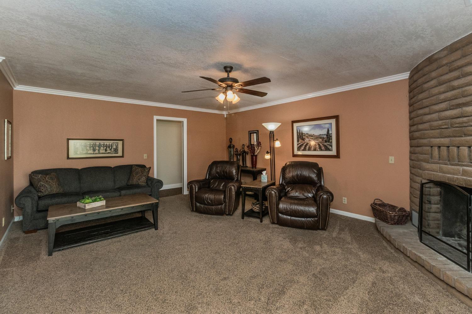 6233 South Armstrong Avenue Fowler, CA 93625 - Photo 9 of 30 a living room with furniture a window and a fireplace