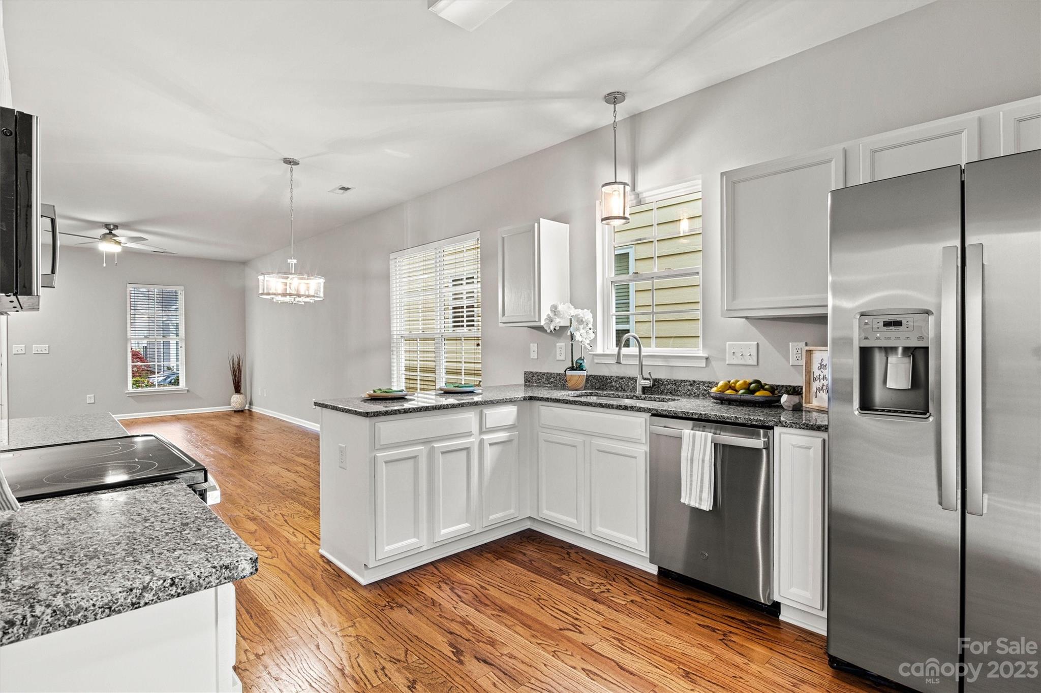 241 Faust Road Davidson, NC 28036 - Photo 12 of 29 a kitchen with stainless steel appliances granite countertop a stove a sink and a refrigerator