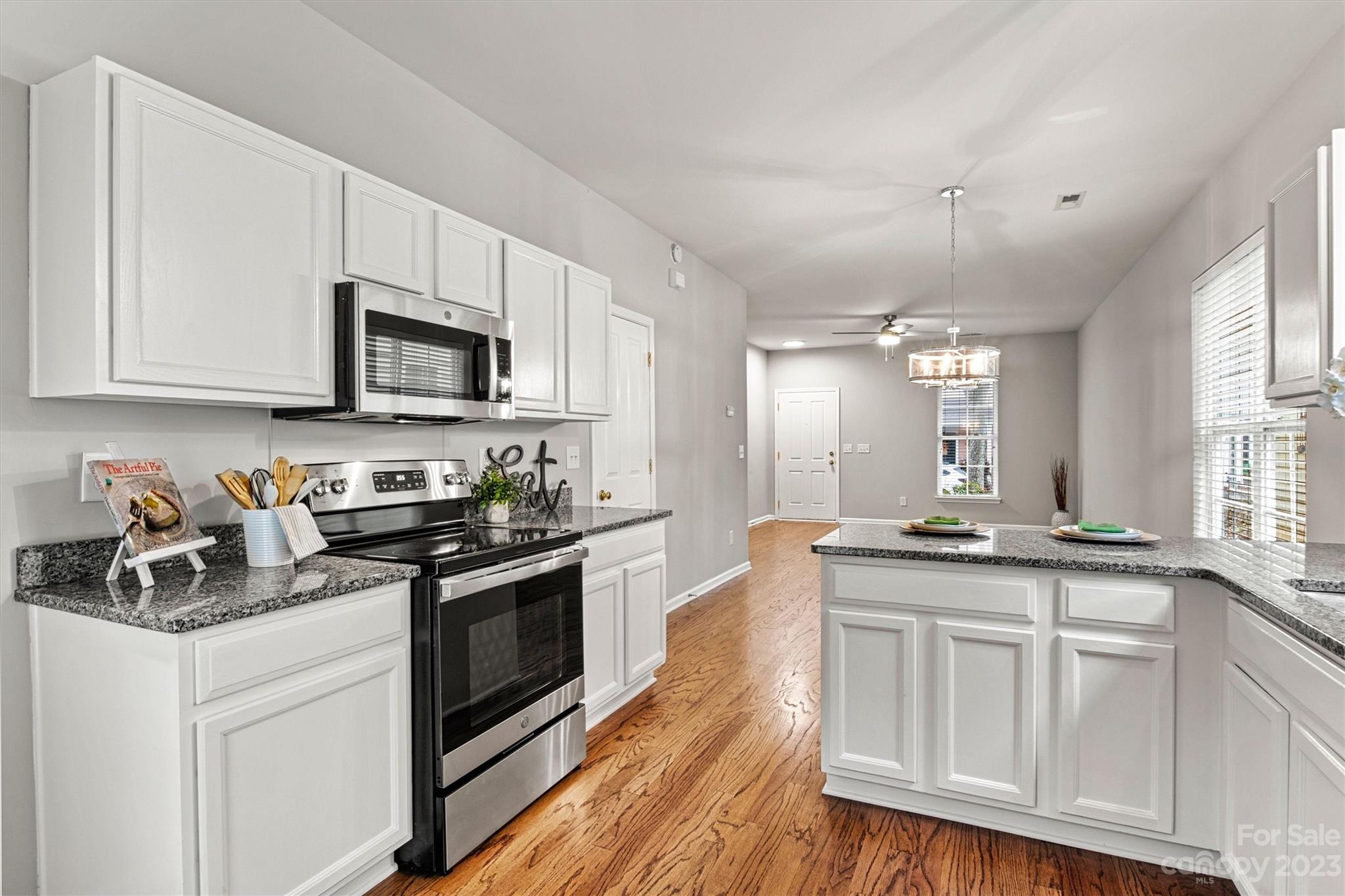 241 Faust Road Davidson, NC 28036 - Photo 13 of 29 a kitchen with granite countertop a sink a counter top space appliances and cabinets