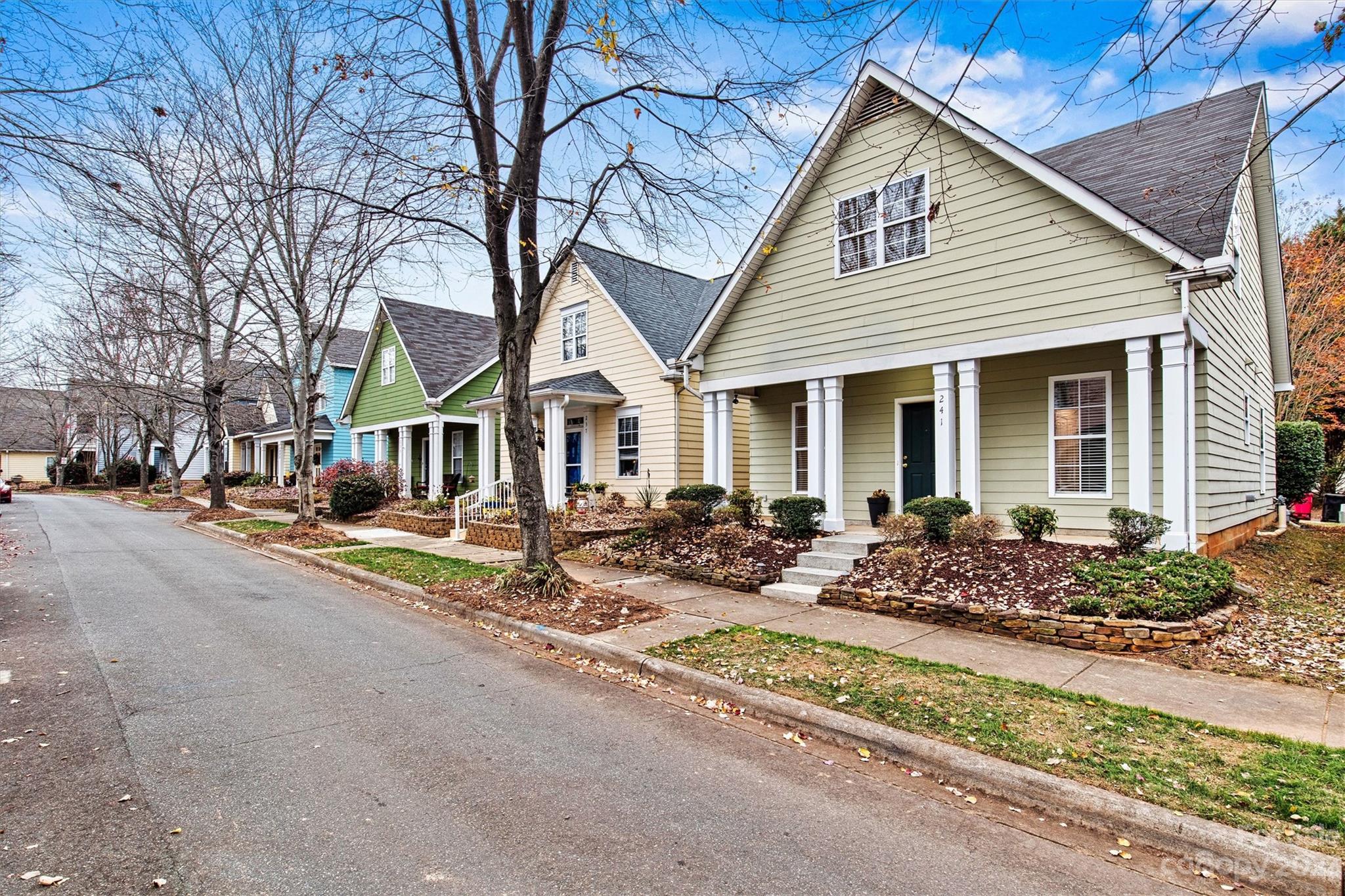 241 Faust Road Davidson, NC 28036 - Photo 2 of 29 a view of a white house with large windows next to a road