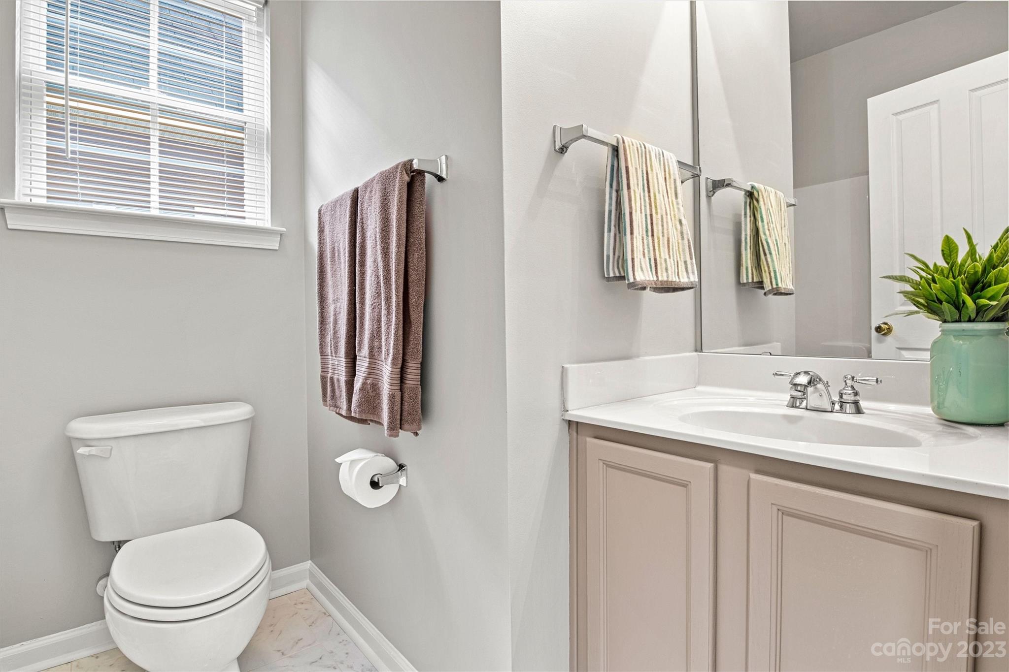 241 Faust Road Davidson, NC 28036 - Photo 22 of 29 a bathroom with a granite countertop toilet sink and mirror