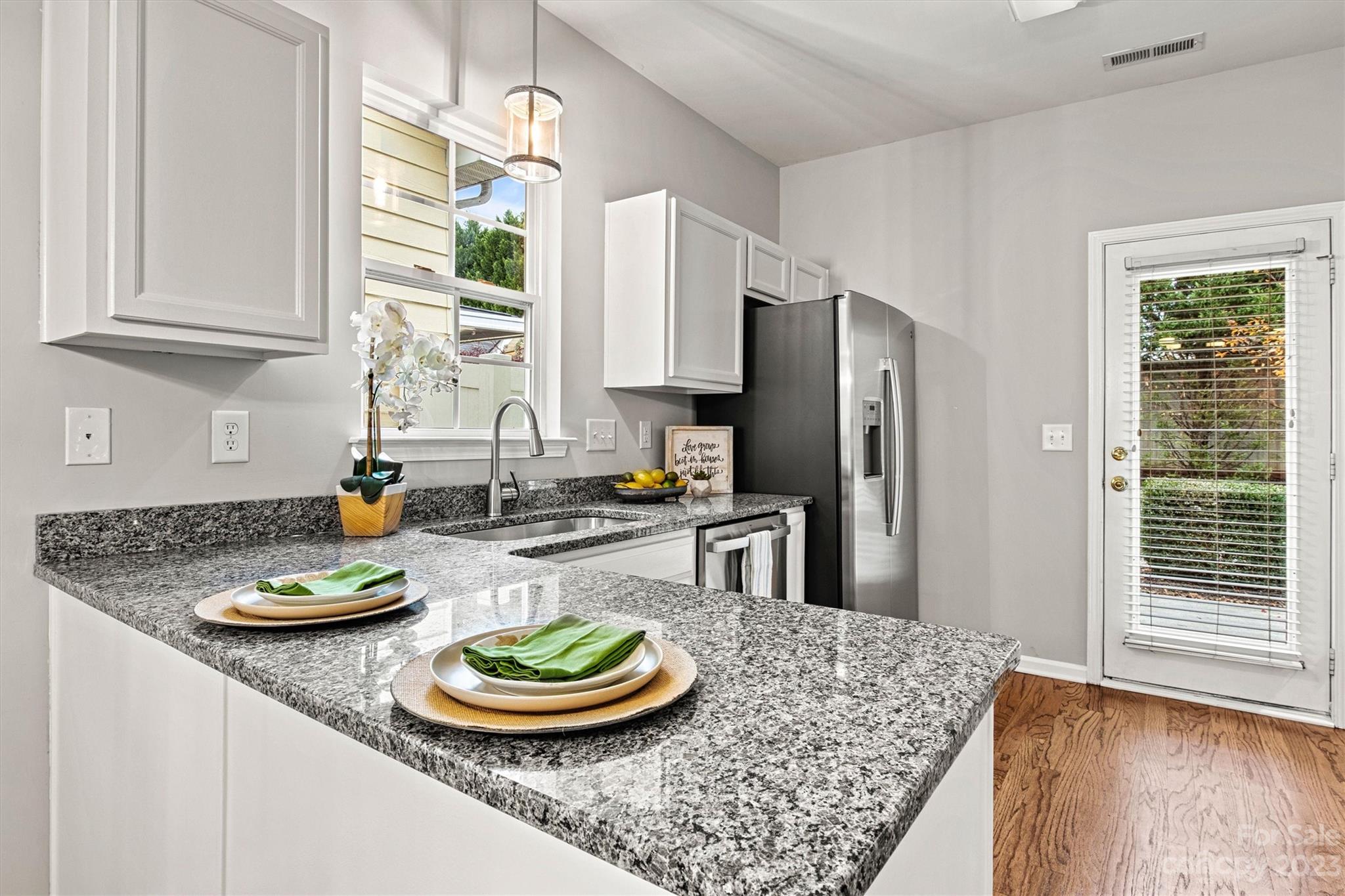 241 Faust Road Davidson, NC 28036 - Photo 9 of 29 a kitchen with stainless steel appliances granite countertop a sink a refrigerator and a stove