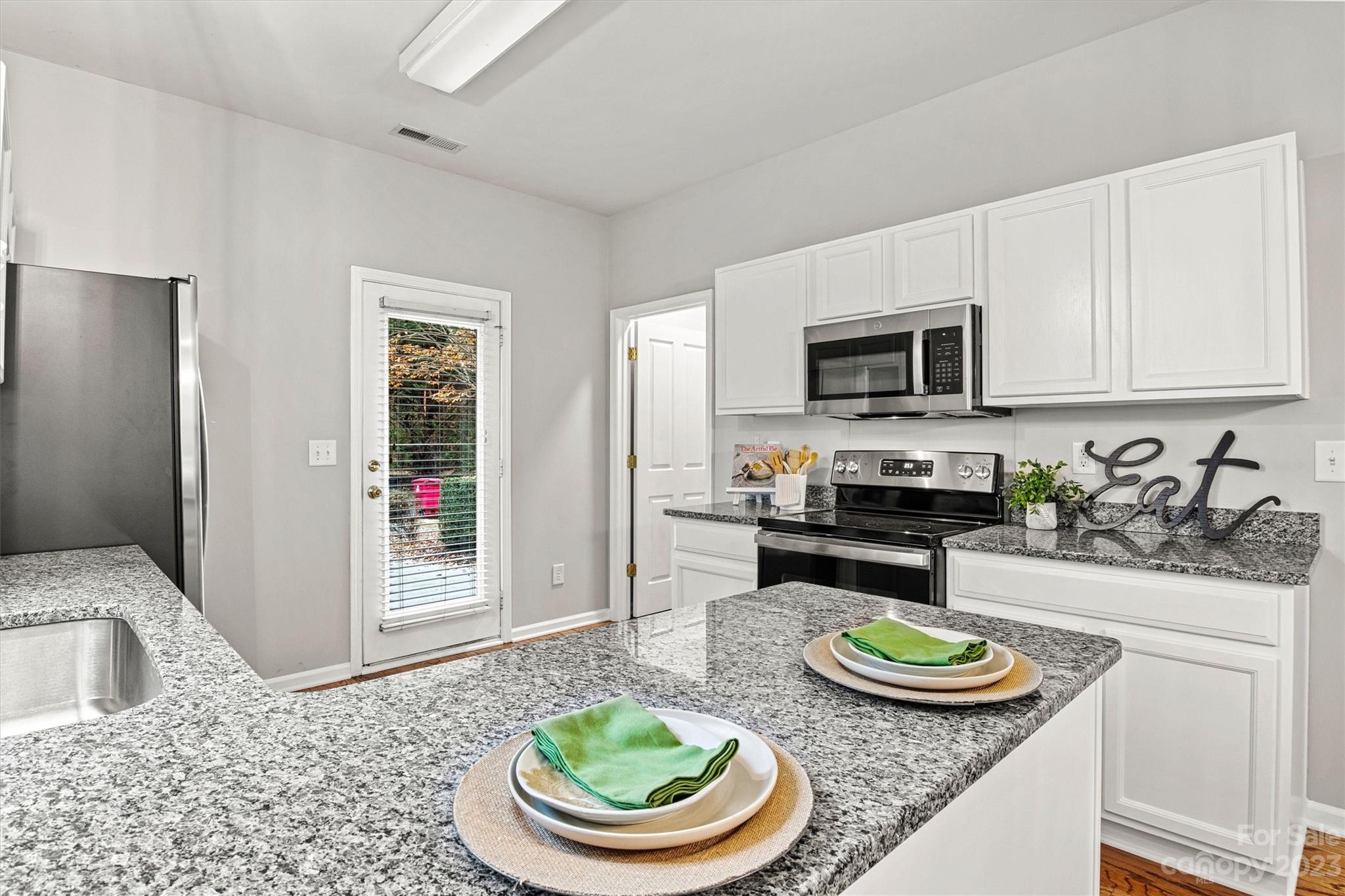 241 Faust Road Davidson, NC 28036 - Photo 10 of 29 a kitchen with sink a stove and cabinets