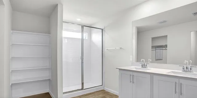 a bathroom with a double vanity sink and a mirror