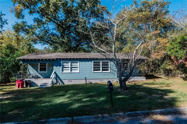 a front view of house with yard and green space
