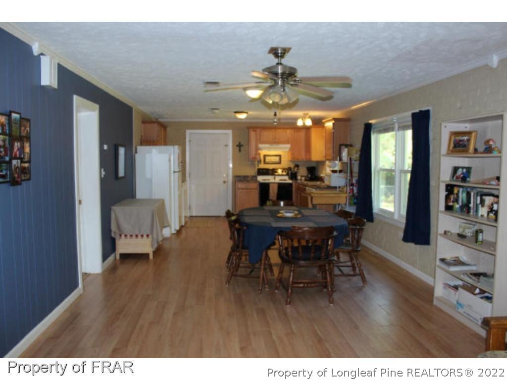 148 Ashemont Road Aberdeen, NC 28315 - Photo 4 of 18 a view of a dining room with furniture and wooden floor