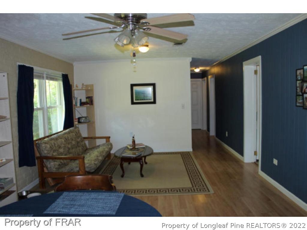 148 Ashemont Road Aberdeen, NC 28315 - Photo 5 of 18 a living room with furniture and a chandelier