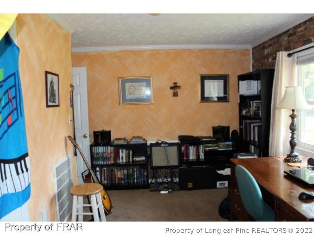148 Ashemont Road Aberdeen, NC 28315 - Photo 6 of 18 a living room with furniture and a dining table