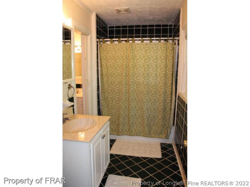 148 Ashemont Road Aberdeen, NC 28315 - Photo 9 of 18 a bathroom with a sink and a shower