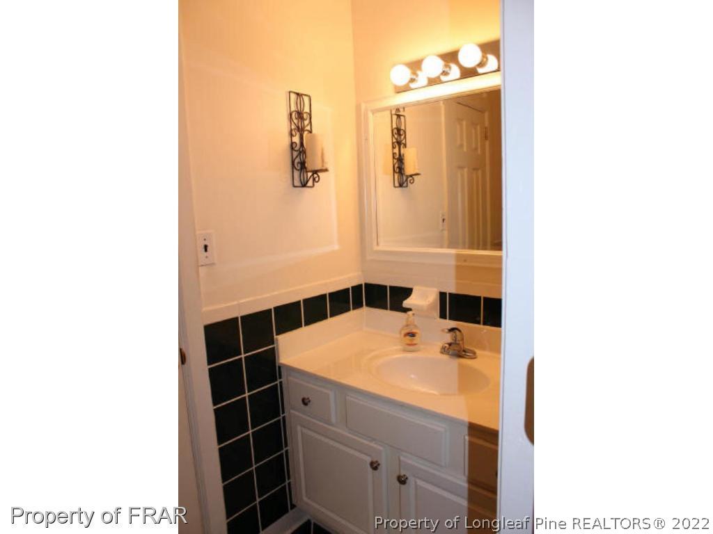 148 Ashemont Road Aberdeen, NC 28315 - Photo 10 of 18 a bathroom with a sink and a mirror